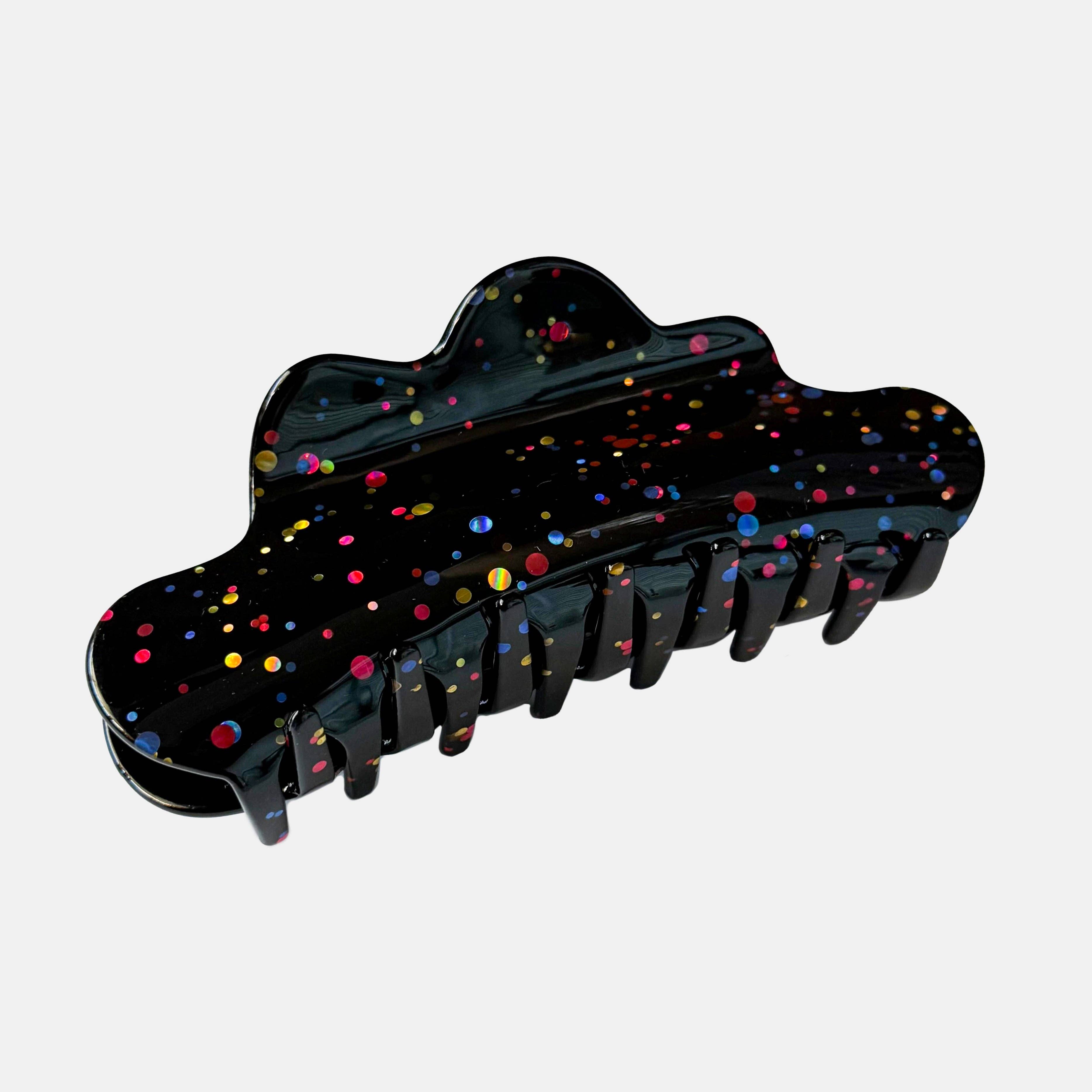 Black hair clip with colorful speckles on a white background