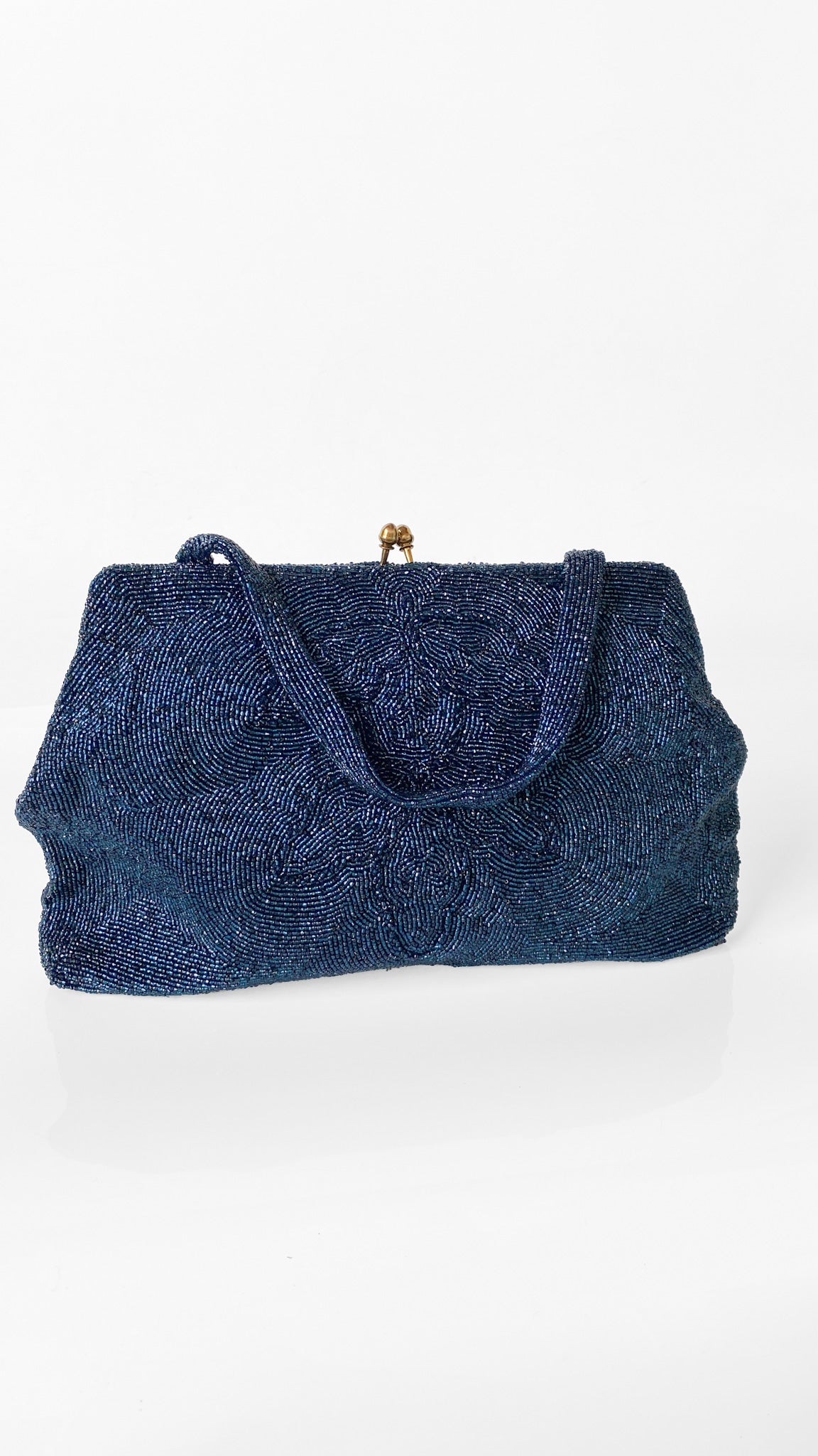 A textured navy blue clutch bag with a small gold-tone metal clasp on a clean white background.