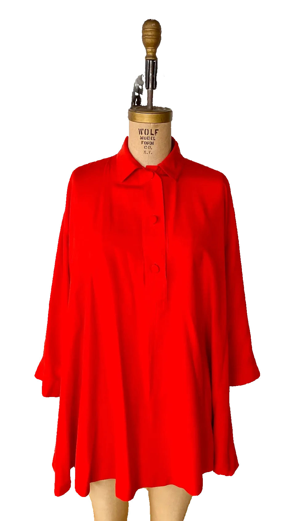 Red top on a mannequin against a white background