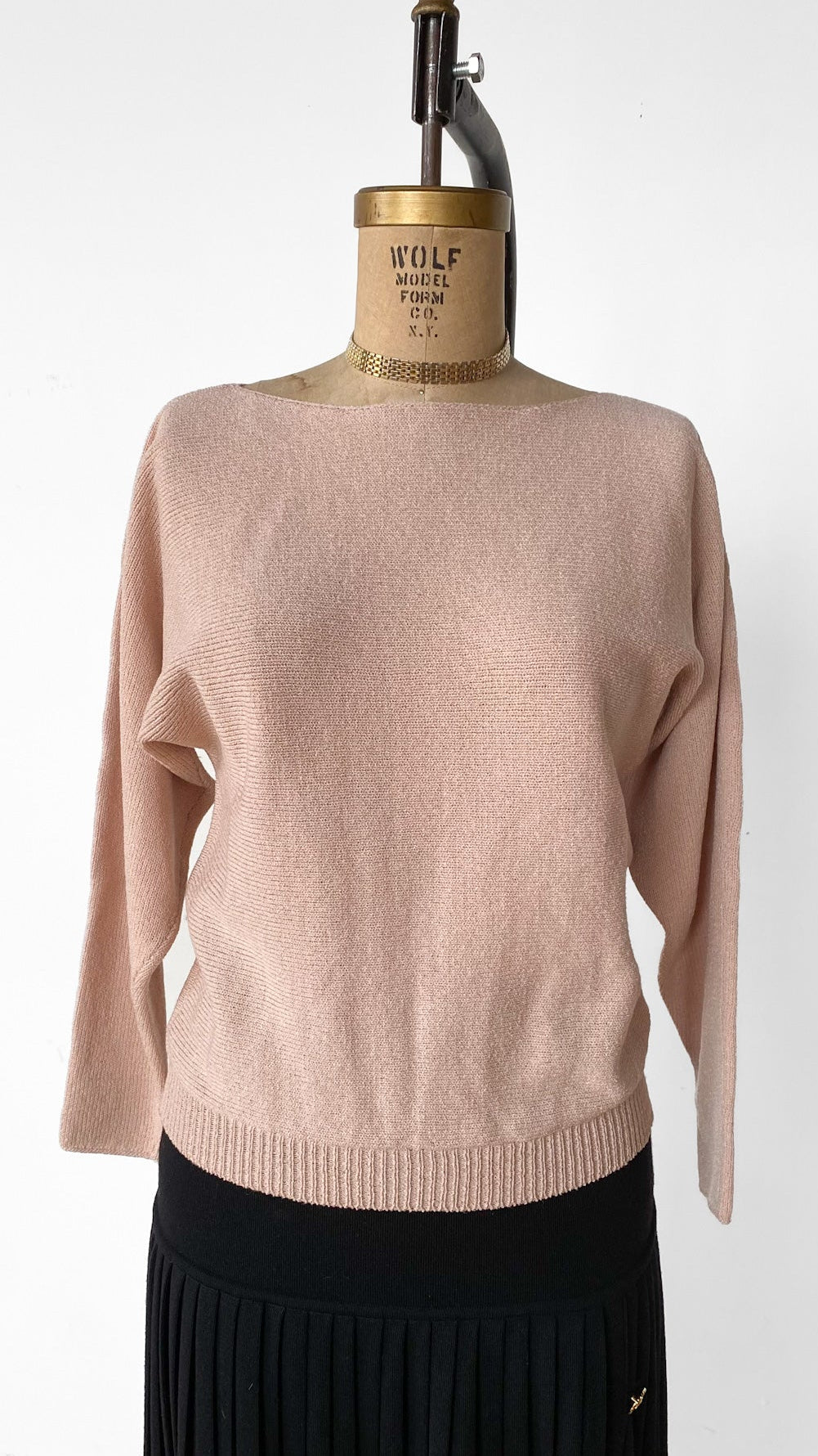 Beige sweater on a mannequin with a white background