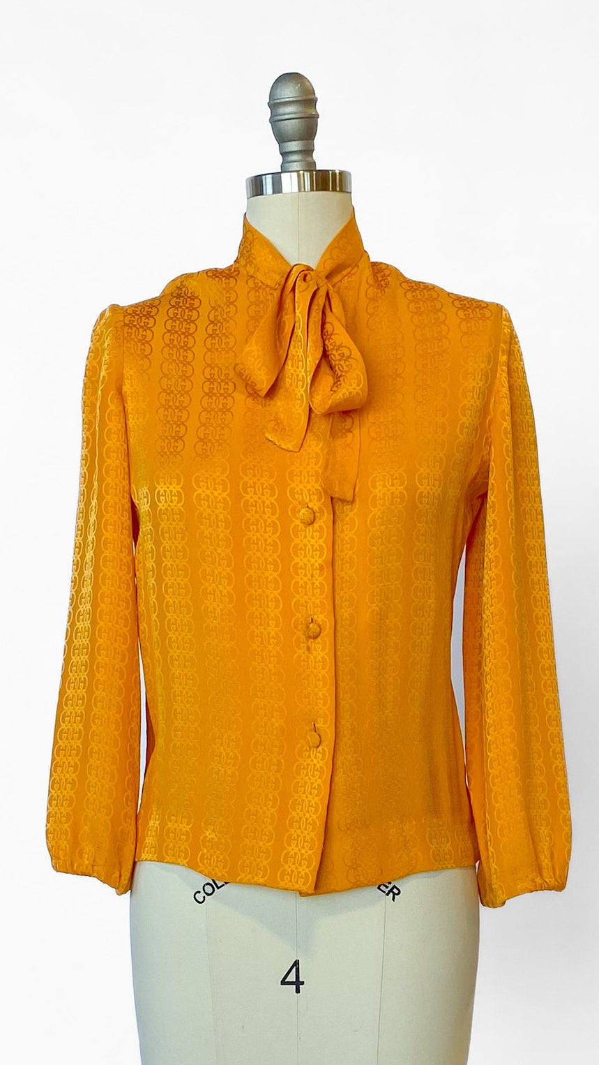 Yellow blouse on a mannequin against a white background