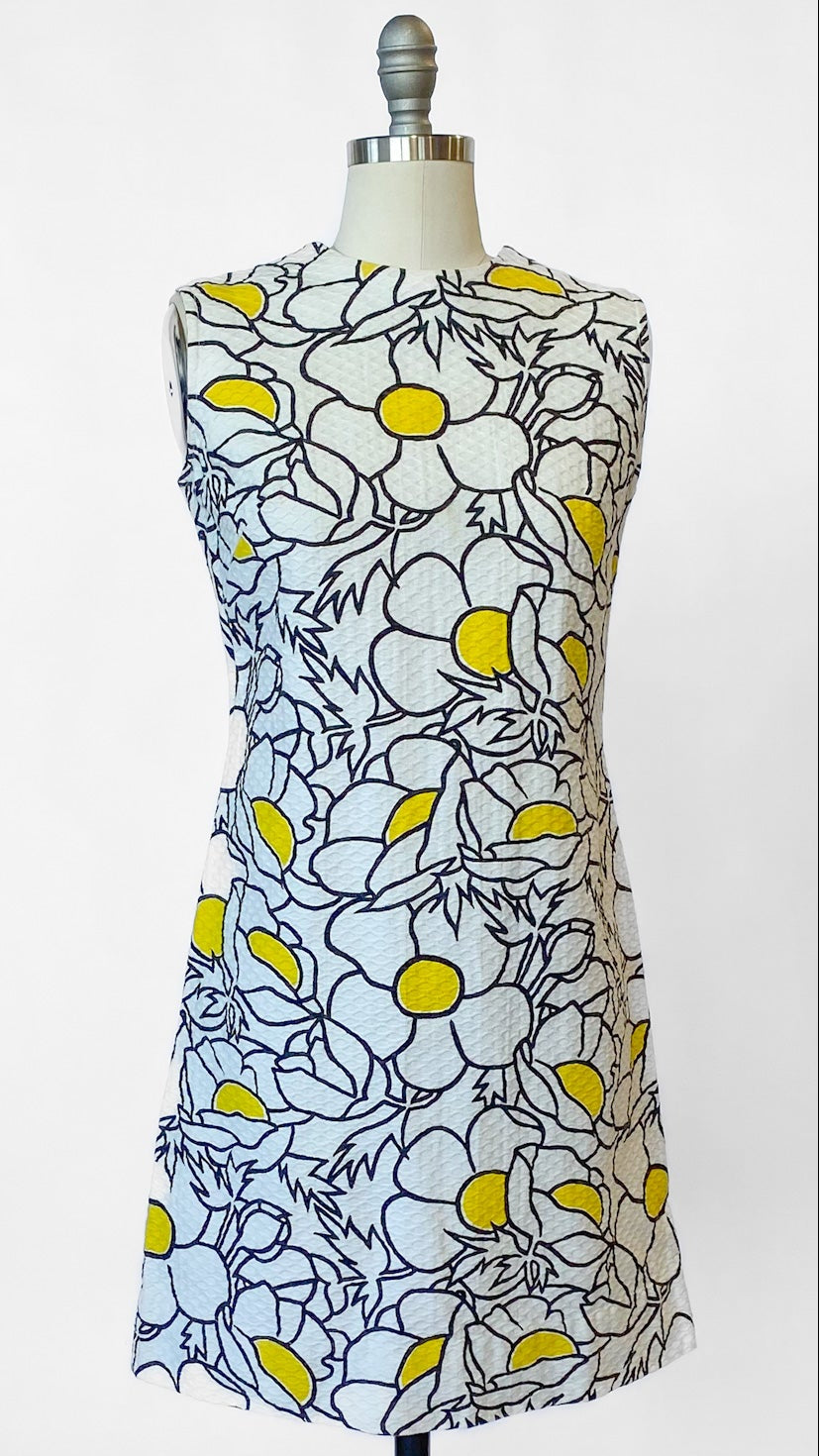 Floral dress on a mannequin against a white background