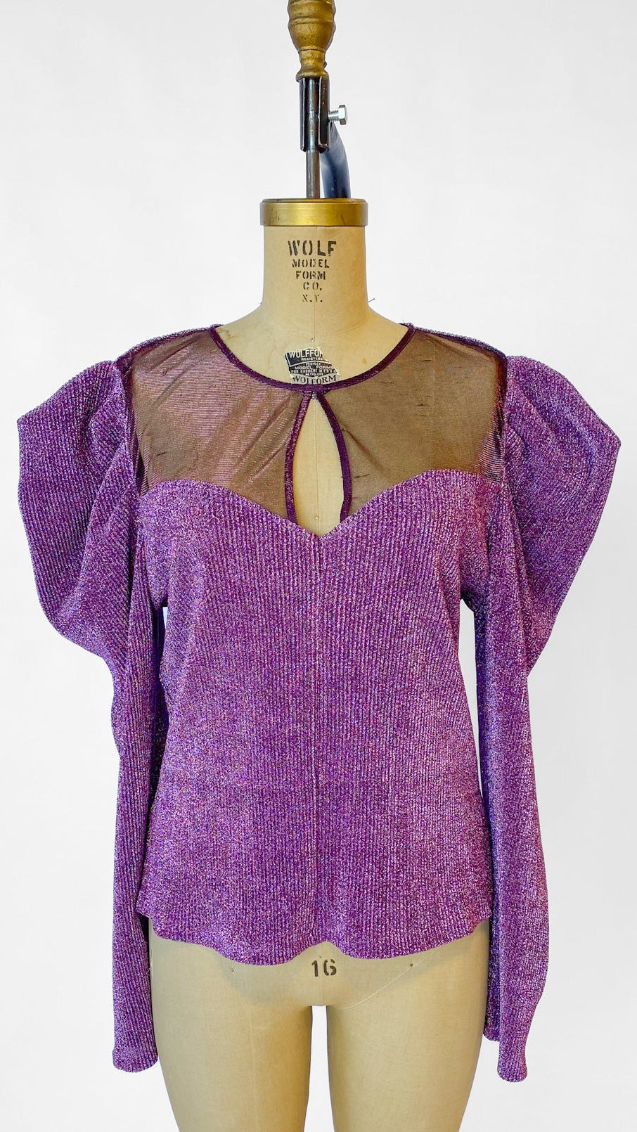 Purple top on a mannequin against a white background