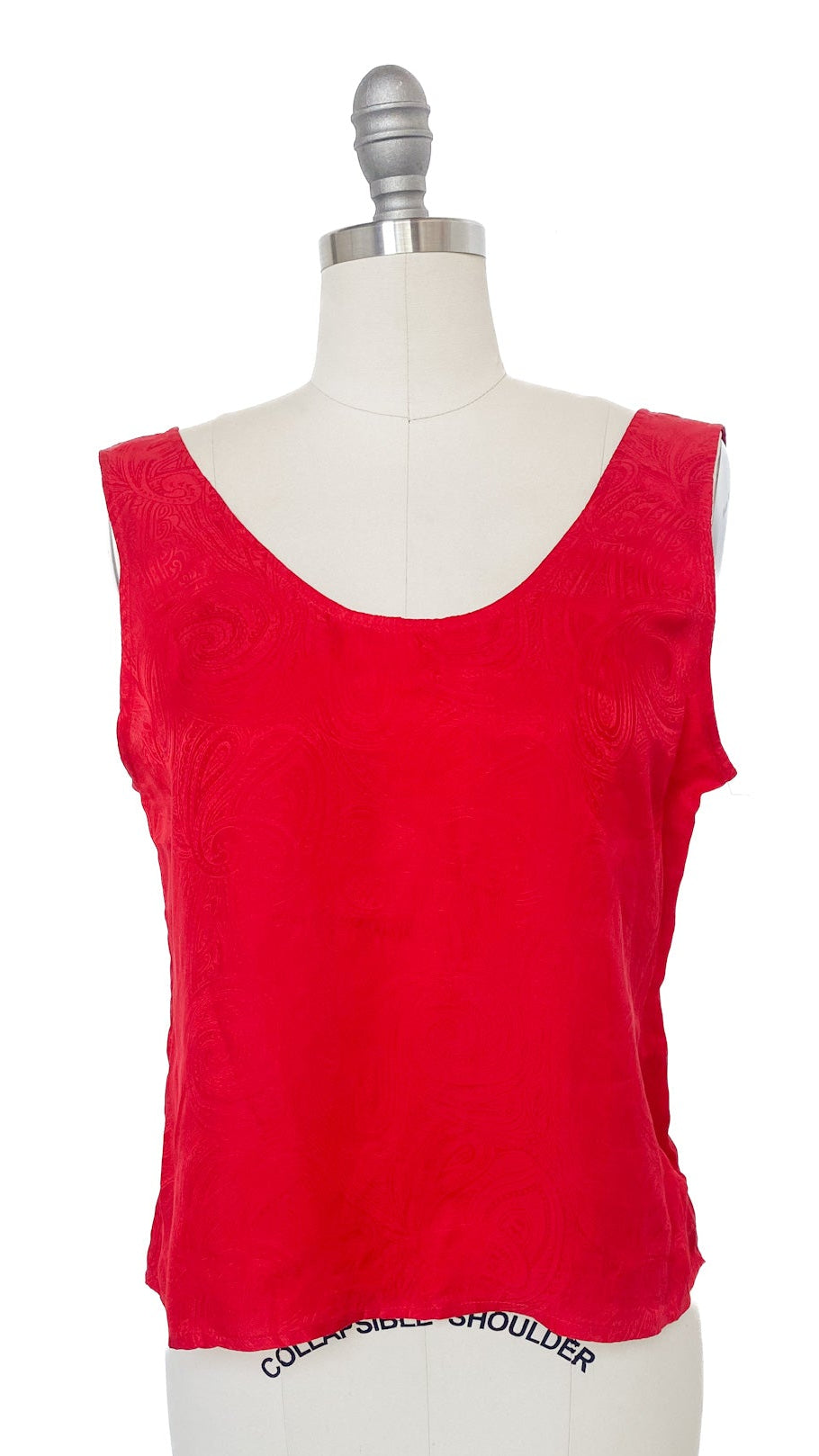 Red tank top on a mannequin with a white background