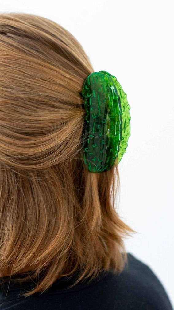 Person with a green hair clip in their hair on a white background
