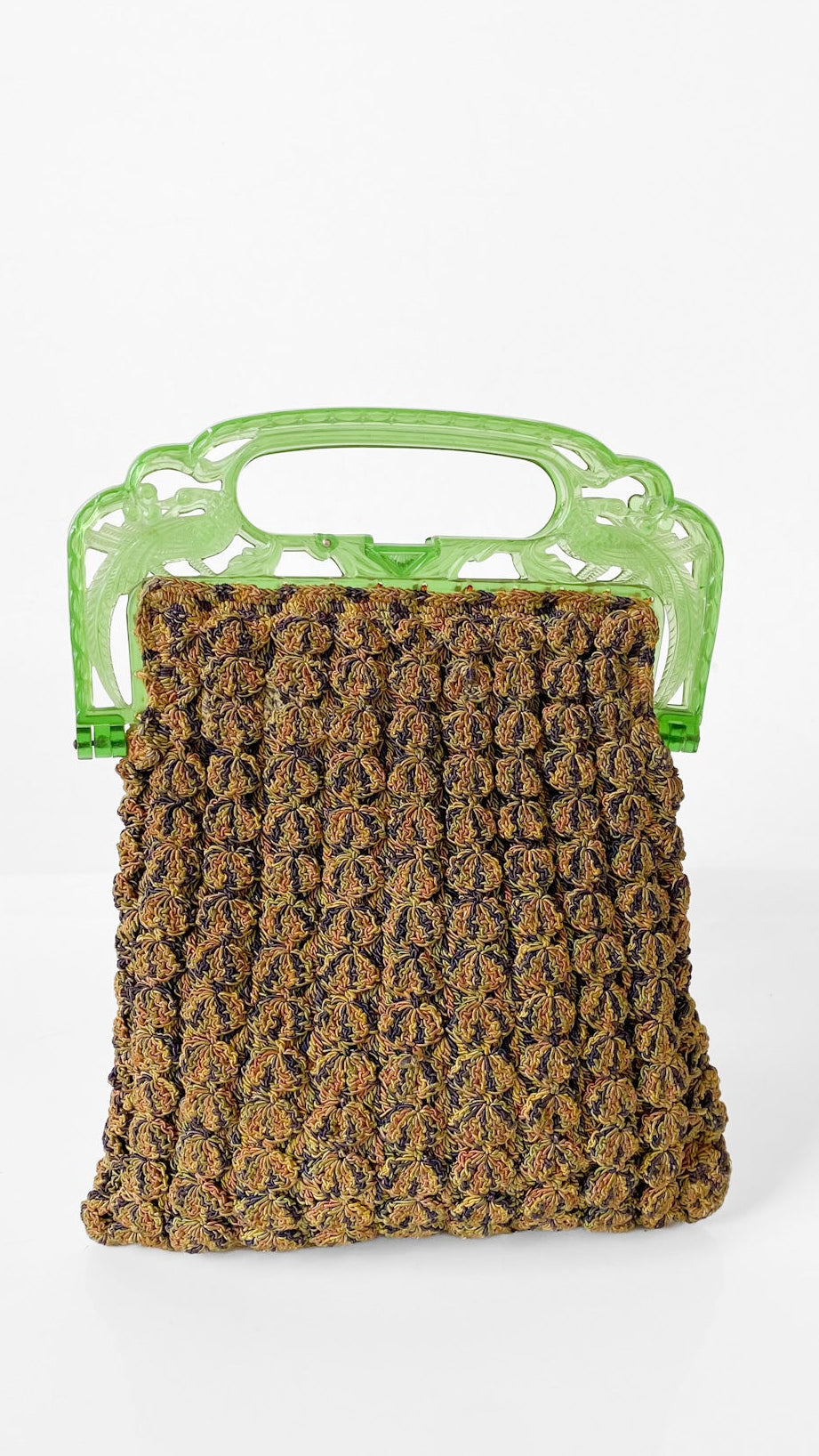 A textured brown and gold woven bag with a translucent light green plastic handle, shown against a plain white background.