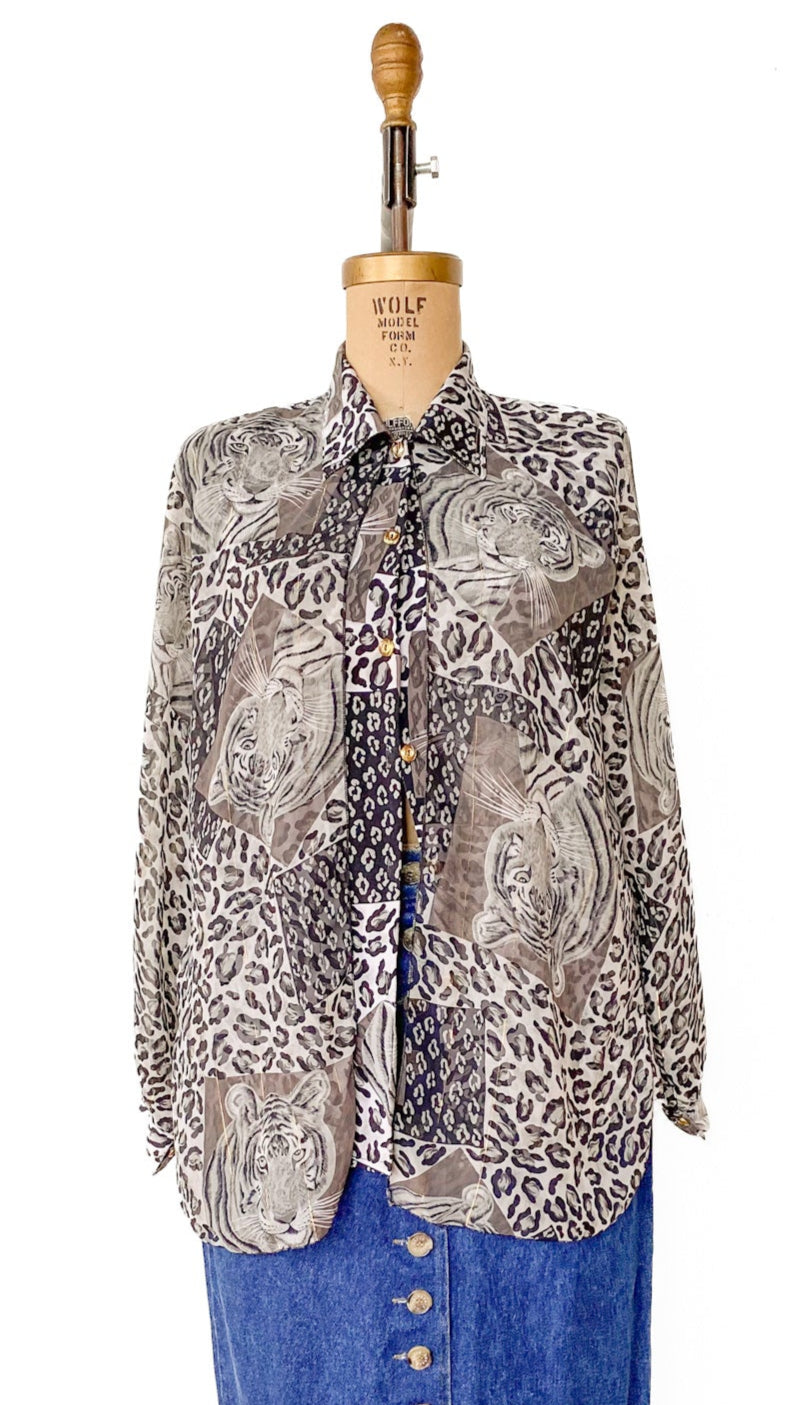 Mannequin wearing a patterned shirt over a blue skirt on a wooden floor.