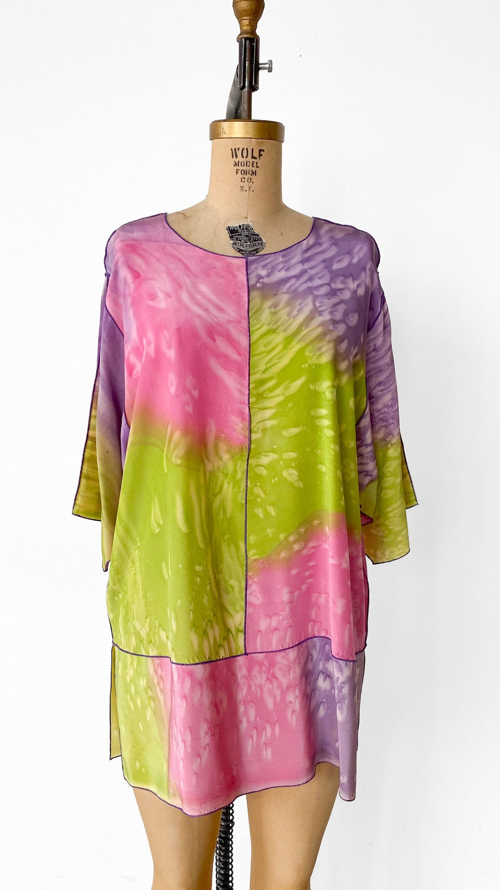 Colorful tie-dye top on a mannequin against a white background