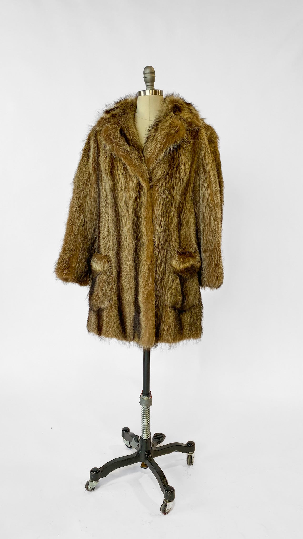 Brown fur coat on a mannequin against a white background