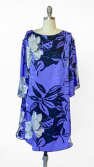 Purple dress with floral pattern on a mannequin against a white background