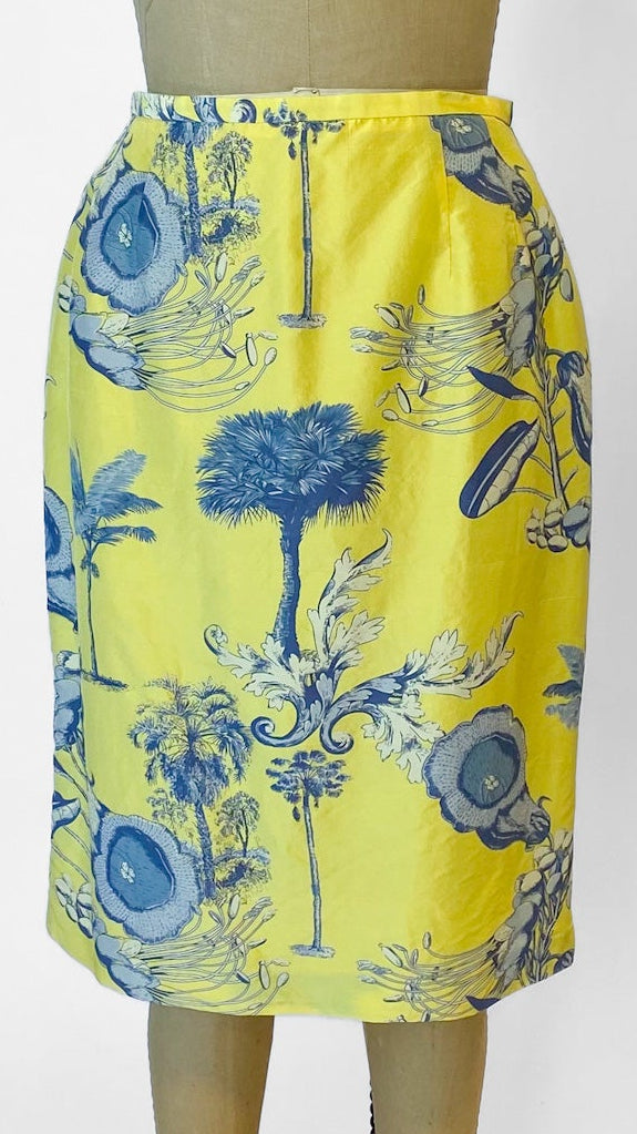 Yellow skirt with blue floral pattern on a mannequin against a white background