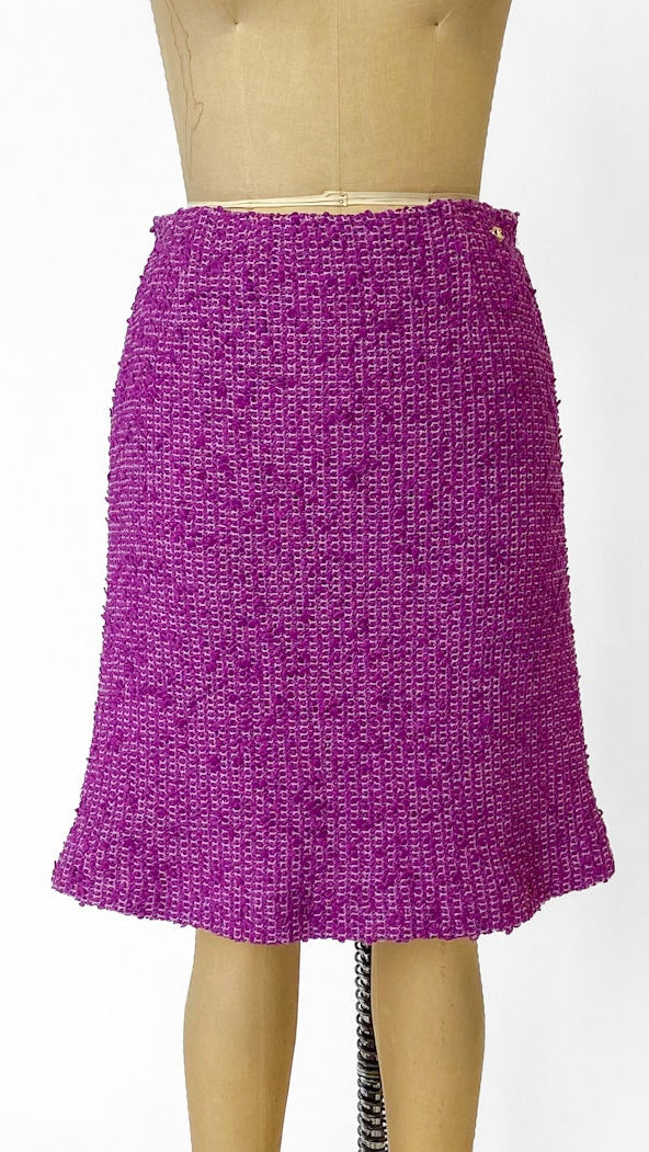 Purple skirt on a mannequin against a white background
