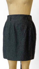 Dark gray skirt on a mannequin against a white background