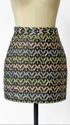 Patterned skirt on a mannequin against a white background