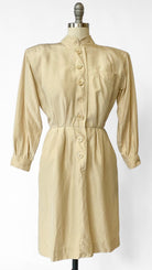 Beige dress on a mannequin against a white background