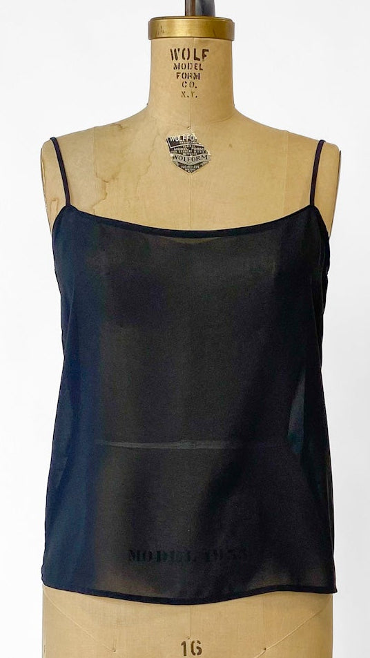 Black tank top on a mannequin against a white background