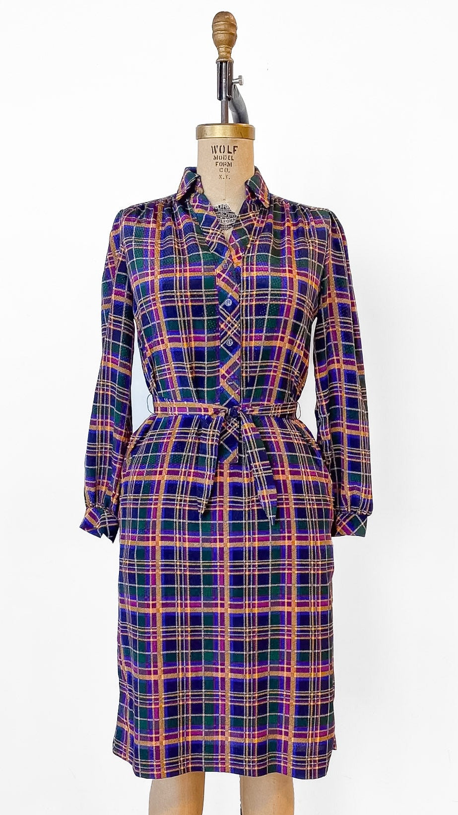 Plaid dress on a mannequin against a white background