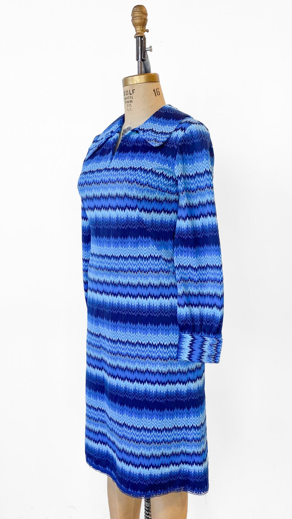 Blue striped dress on a mannequin against a white background