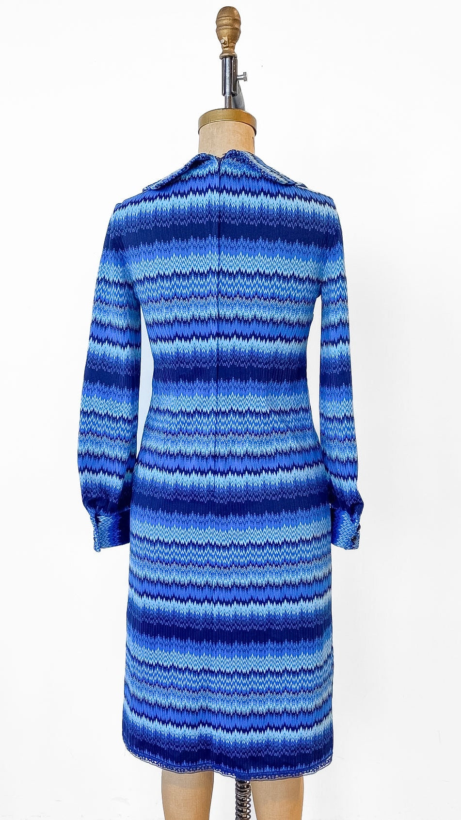 Blue striped dress on a mannequin against a white background