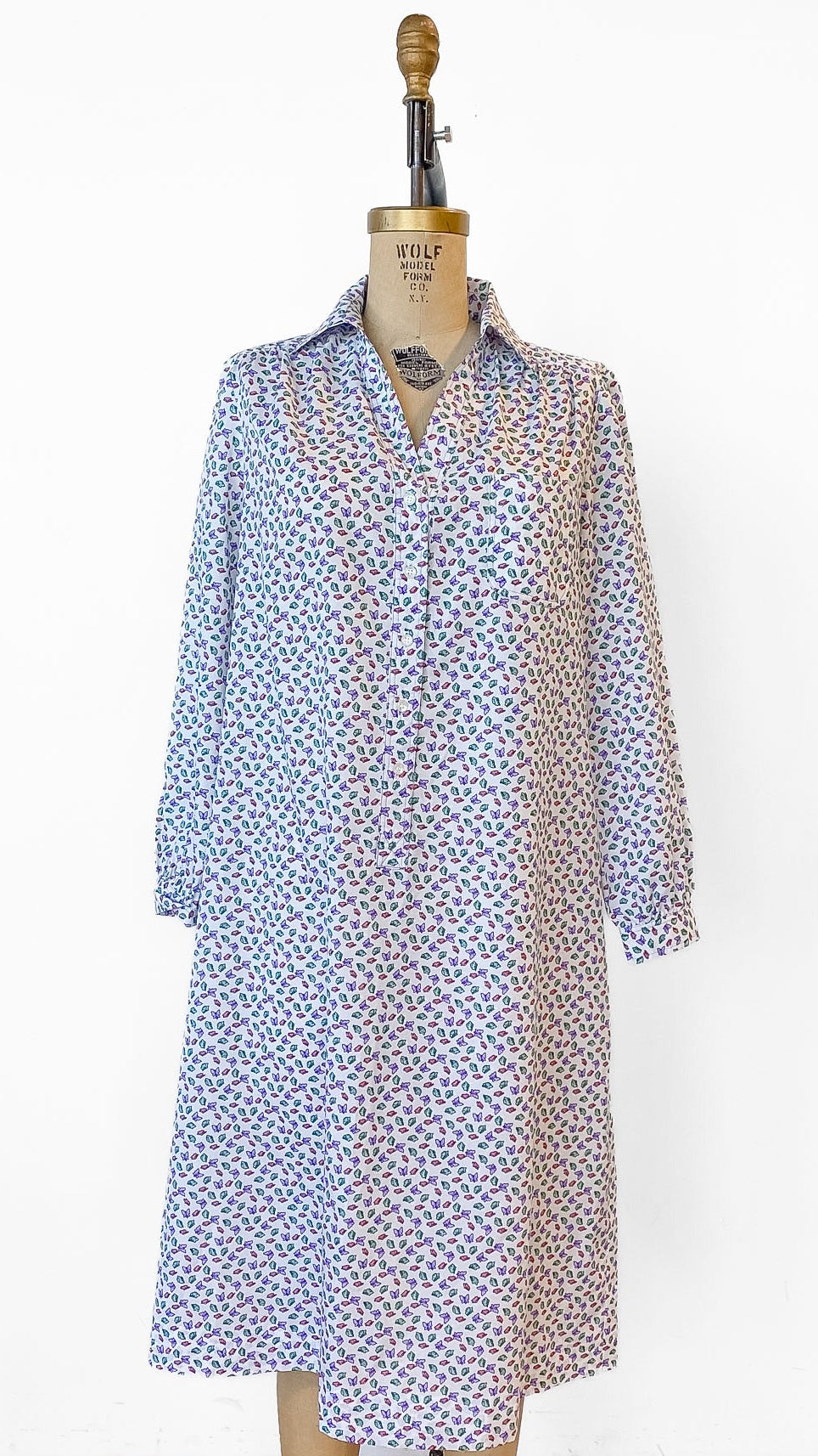 Long blue and white patterned dress on a mannequin against a white background