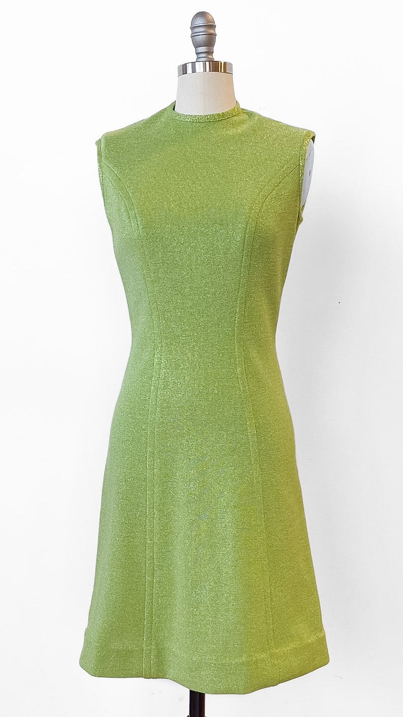 Green dress on a mannequin against a white background