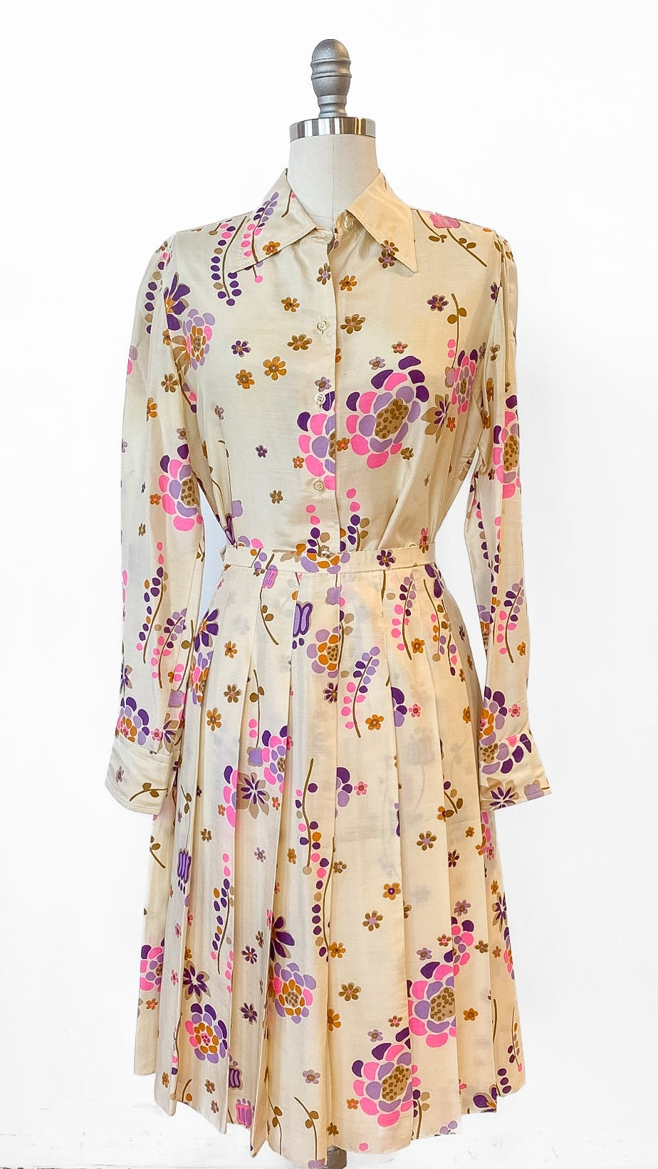 Floral dress on a mannequin against a white background