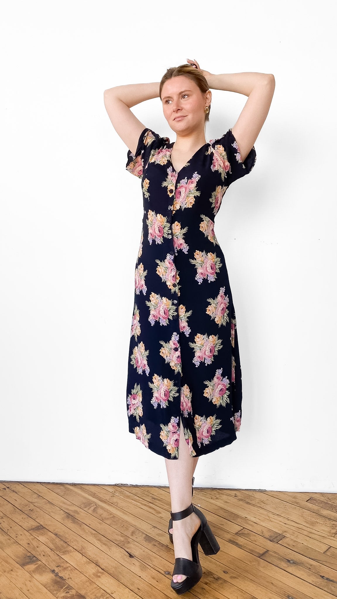 Woman wearing a floral dress against a white background