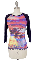Colorful top with 'Guess' branding on a mannequin against a white background