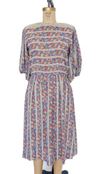 Multicolored patterned dress on a mannequin against a white background