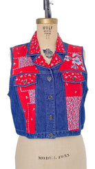 Patchwork vest with red and blue patterns on a mannequin against a white background