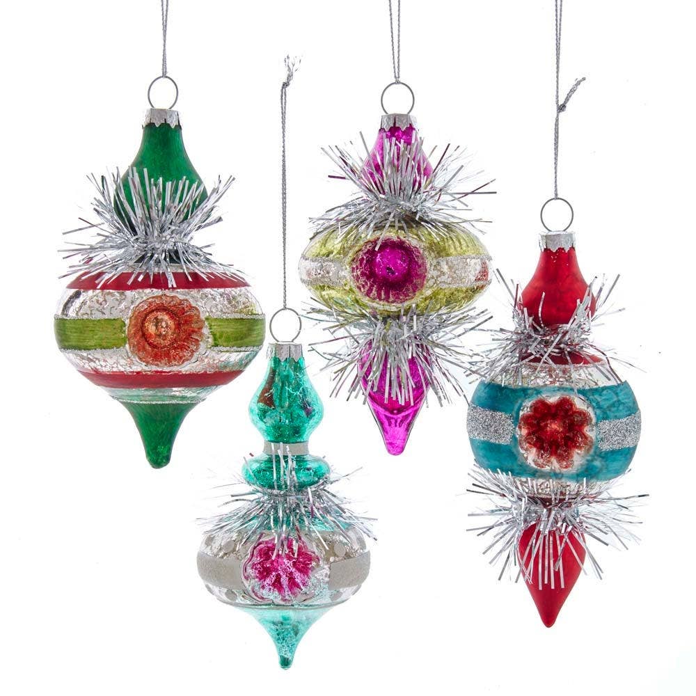 Set of colorful Christmas ornaments with tinsel details on a white background
